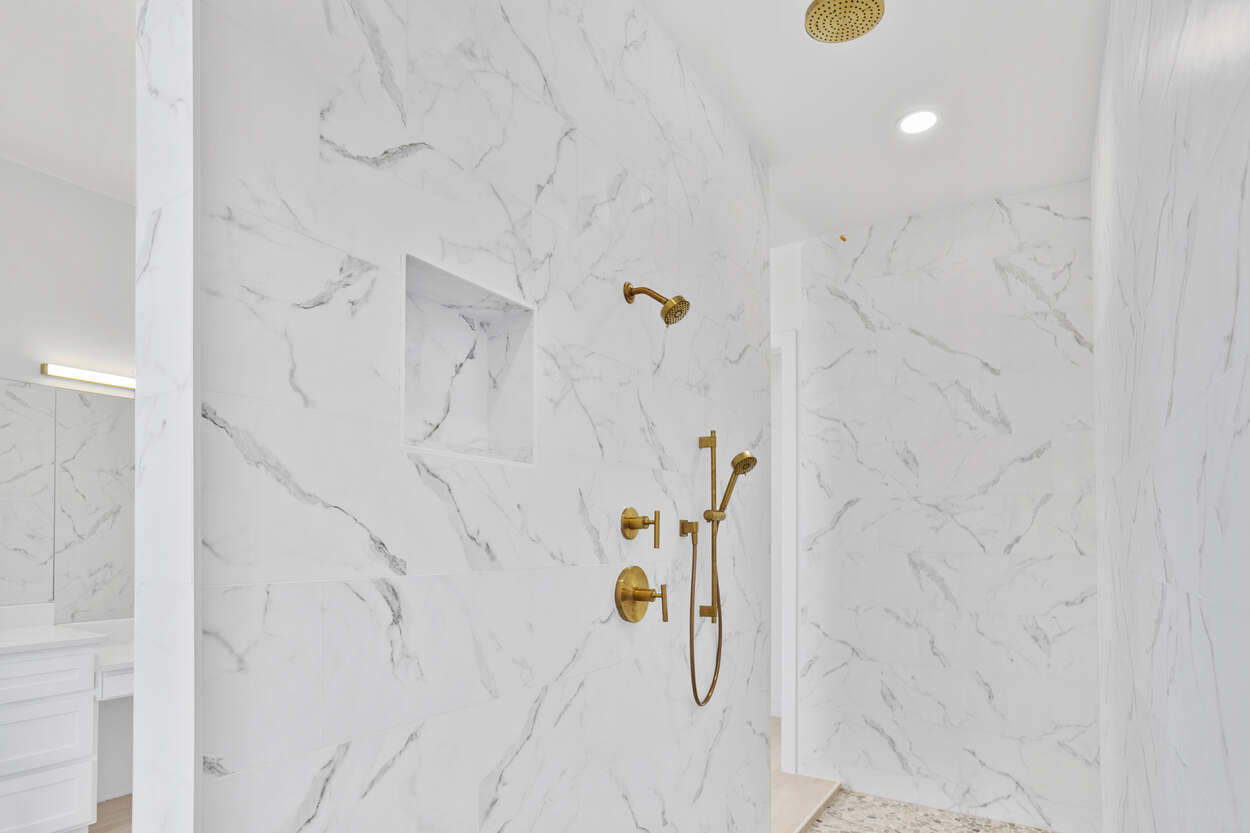 2200 Hacienda Rey marble shower with gold fixtures